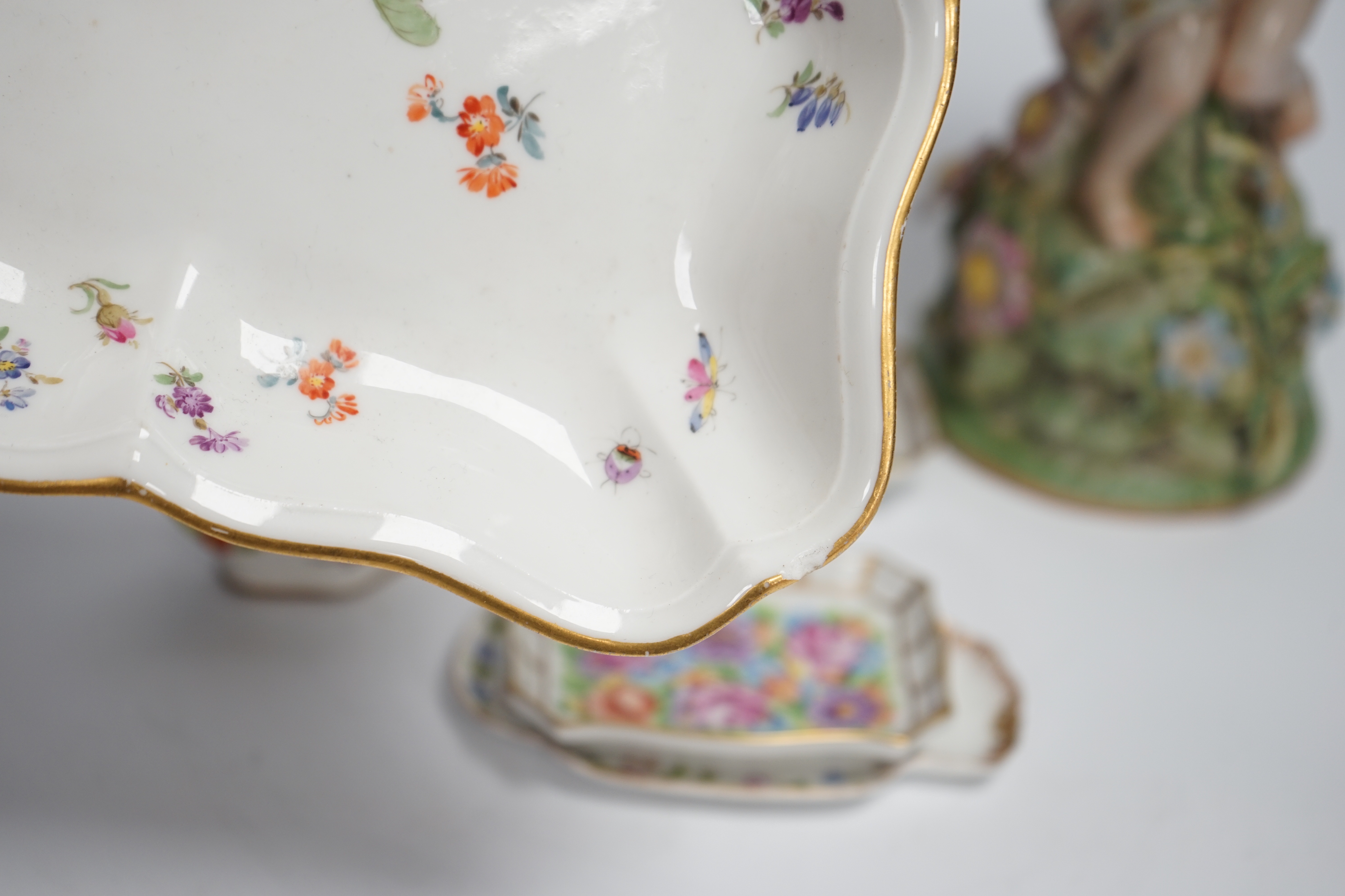 A German porcelain figural centrepiece, a Meissen floral dish, and various Dresden dishes, tallest 29cm